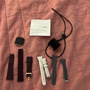 Fitbit Versa 2 and charger with extra watch bands